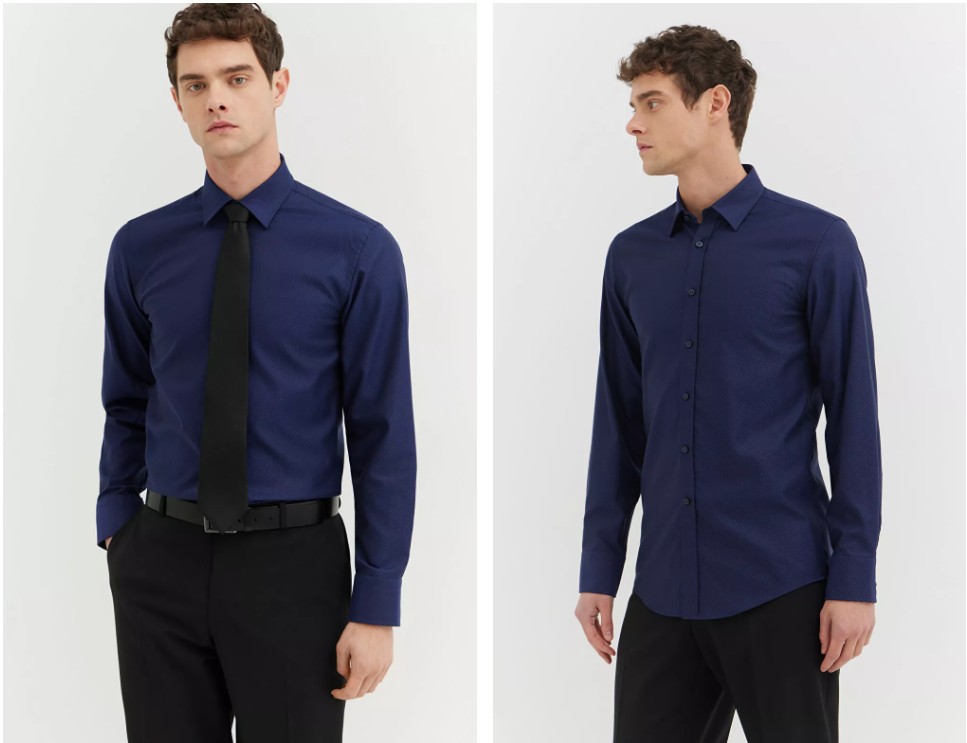 mężczyzna w granatowej koszuli z czarnym krawatem, stoi na białym tle